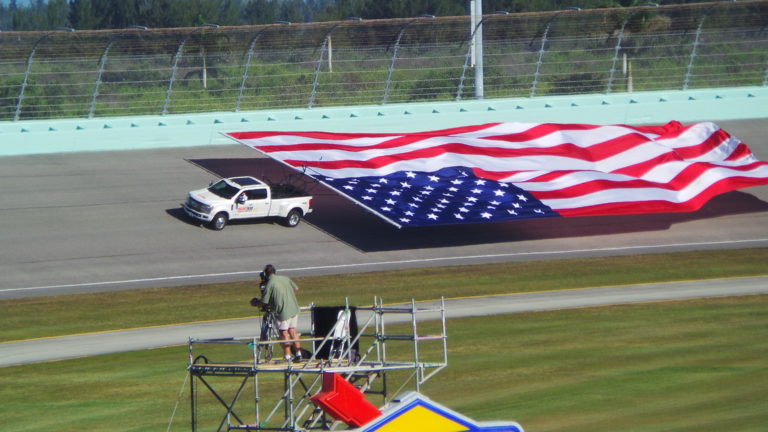 American flag unfurled on track before the race for Homestead NASCAR Ticket Packages guests at Homestead-Miami Speedway