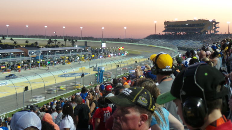 Fans watching the NASCAR Championship race at Homestead-Miami Speedway at sunset