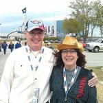 Race fans smiling outside Homestead-Miami Speedway before the NASCAR Championship race