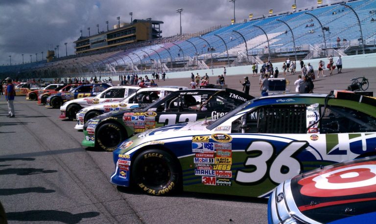 Stock cars lined up on pit road before the race during the Homestead NASCAR Ticket Package weekend at Homestead-Miami Speedway.