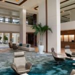 Modern open lobby at the Hilton Miami Airport Blue Lagoon with comfortable seating and tropical accents