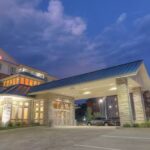 RaceAway Bristol NASCAR Ticket Packages include the Hilton Garden Inn Pigeon Forge at dusk with warm lights and clear evening skies.