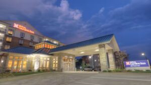 RaceAway Bristol NASCAR Ticket Packages include the Hilton Garden Inn Pigeon Forge at dusk with warm lights and clear evening skies.