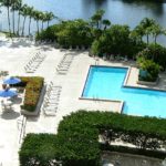 Aerial view of the Hilton Miami Airport Blue Lagoon pool and waterfront area surrounded by palm trees