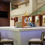 Hilton Miami Airport Blue Lagoon lobby bar welcoming Homestead NASCAR Ticket Packages guests