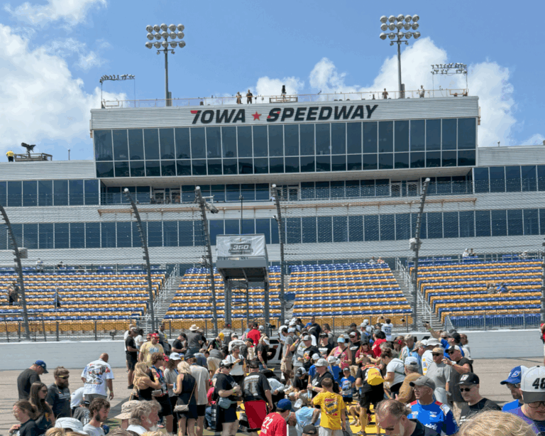 Fans gather on the frontstretch at Iowa Speedway with the tower in the background, part of Iowa NASCAR Ticket Packages.