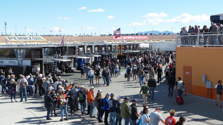 Fans walking through the Neon Garage infield area at Las Vegas Motor Speedway during NASCAR weekend