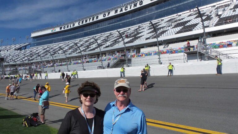 RaceAway Daytona NASCAR packages guests standing on the frontstretch at Daytona International Speedway during pre-race activities