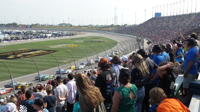 Crowds fill the grandstands at Kansas Speedway as NASCAR race cars thunder around the 1.5-mile oval during a thrilling race.