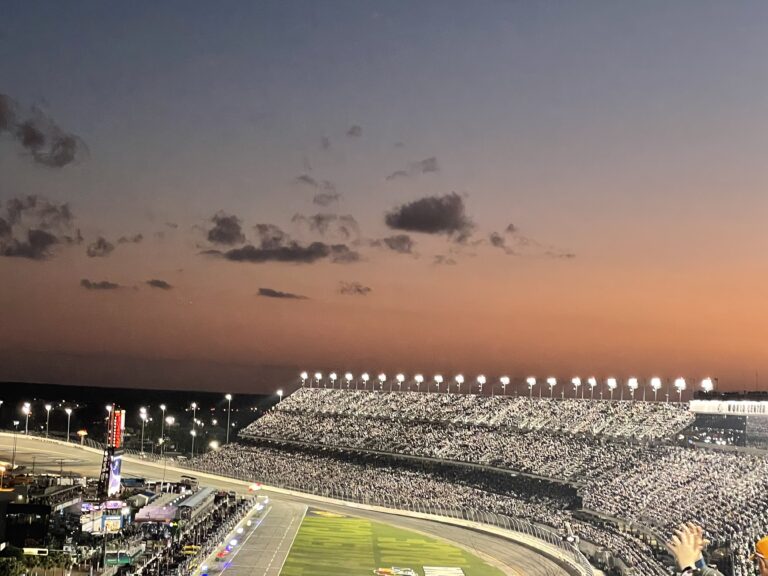 Sunset over Daytona International Speedway with grandstands full of NASCAR fans during race night
