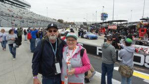 Fans standing on pit road with cars and crews preparing at Martinsville Speedway