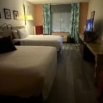 Modern hotel room near Bristol Motor Speedway with two queen beds, TV, and seating area