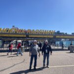 Two RaceAway guests standing outside the Phoenix Raceway entrance at Gate 4.