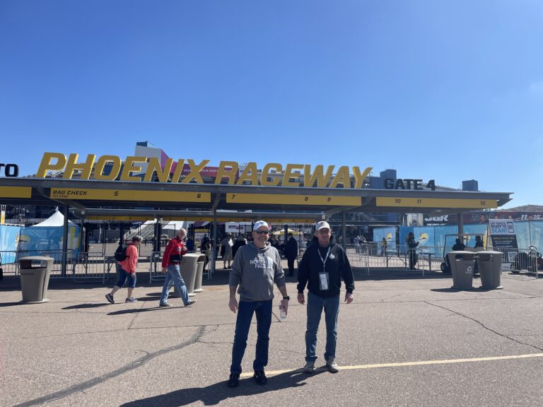 Two RaceAway guests standing outside the Phoenix Raceway entrance at Gate 4.