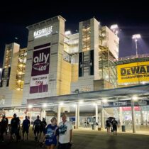 Nashville Superspeedway entrance lit up at night with Nashville NASCAR Ticket Packages