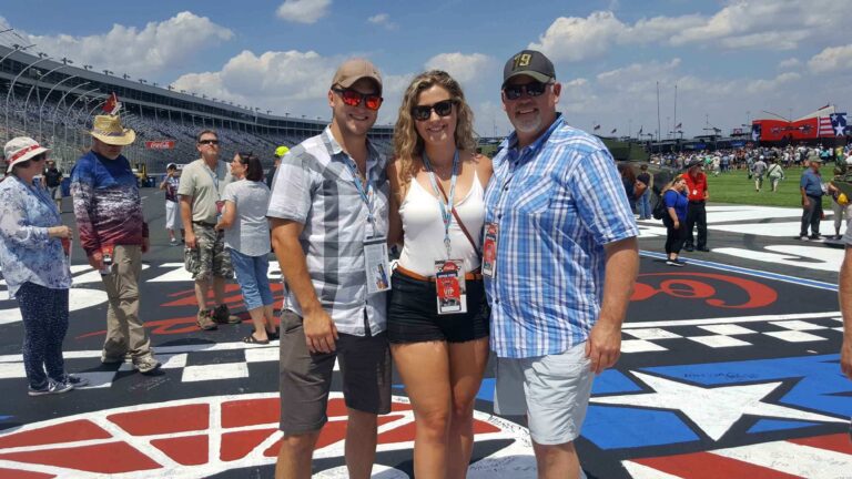 Race fans standing on the start/finish line at Charlotte Motor Speedway
