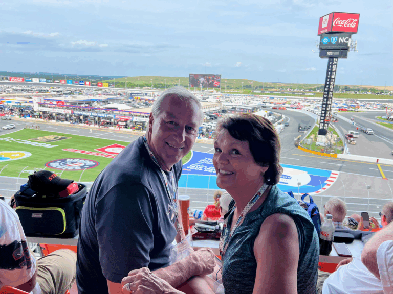 Couple enjoying the race from grandstand seats at Charlotte Motor Speedway.