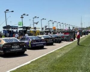 NASCAR race cars lined up on pit road at Kansas Speedway ahead of the race