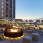 Luxury Myrtle Beach hotel terrace with fire pit and poolside seating, included in select Darlington NASCAR Ticket Packages.