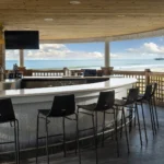 Beachfront hotel bar with ocean views and shaded seating at a Myrtle Beach resort.