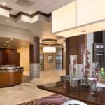 Front desk at Embassy Suites Des Moines Downtown with welcoming staff ready for NASCAR guests.