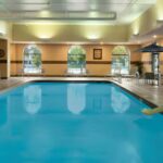 Indoor pool at Embassy Suites Des Moines Downtown, offering relaxation after Iowa NASCAR Tickets events.