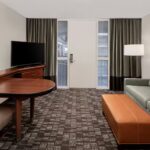 Embassy Suites Nashville Airport living room with sofa and TV