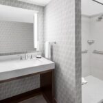 Modern bathroom at Embassy Suites Nashville Airport featured in Nashville NASCAR Packages