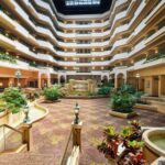 Spacious atrium at Embassy Suites Greensboro Airport where RaceAway Hospitality guests relax during Martinsville NASCAR race weekends.