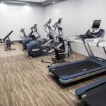 Embassy Suites Orlando North fitness center with treadmills, ellipticals, and weights, included in Daytona NASCAR Packages.