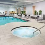 Embassy Suites Orlando North indoor pool and whirlpool area, a relaxing amenity included with Daytona NASCAR Ticket Packages.