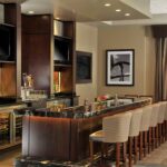 Stylish atrium lounge at Embassy Suites Des Moines Downtown, ideal for Iowa NASCAR Packages guests.