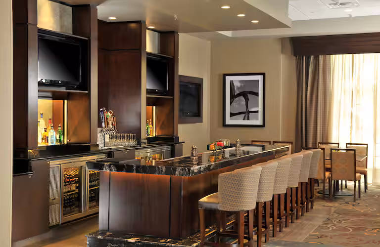 Stylish atrium lounge at Embassy Suites Des Moines Downtown, ideal for Iowa NASCAR Packages guests.