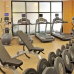 Fitness center at Embassy Suites Des Moines Downtown with treadmills, weights, and equipment for Iowa NASCAR Packages guests.