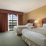 Spacious two-bed suite at Embassy Suites Greensboro for guests booking a Martinsville NASCAR Ticket Package.