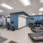 Fitness center at Embassy Suites Atlanta Airport hotel with treadmills, exercise bikes, and strength equipment