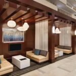 Embassy Suites Atlanta Airport hotel lobby seating area with modern decor and semi-private booths