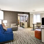 Spacious suite living area at Embassy Suites Charlotte included with Charlotte NASCAR Hotels and Charlotte Coca Cola NASCAR Ticket Packages
