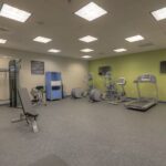 Modern fitness center with cardio machines and weights at the Hilton Garden Inn Pigeon Forge.