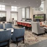 Modern lobby and lounge area at Embassy Suites Birmingham Hoover for guests enjoying a Talladega NASCAR Ticket Package