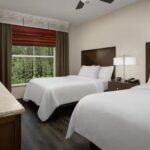 Bright two-bed guest room at Embassy Suites Birmingham Hoover offering a relaxing stay for NASCAR race weekend guests