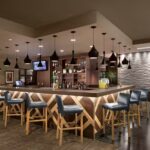 Modern bar at Embassy Suites Phoenix – Tempe hotel included with our Phoenix NASCAR Ticket Package