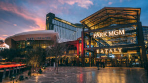 Evening exterior view of Park MGM and Eataly entrance glowing under the Las Vegas sunset.