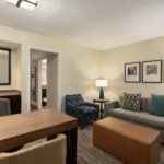 Spacious suite with living area and work desk at Embassy Suites Phoenix – Tempe, part of our Phoenix NASCAR Hotels.