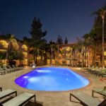 Night view of the illuminated outdoor pool at Embassy Suites Phoenix – Tempe, featured in our Phoenix NASCAR Hotels and Phoenix NASCAR Ticket Packages.