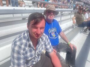 Two RaceAway guests sit in the grandstands at Las Vegas Motor Speedway during a NASCAR race weekend.