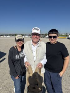 Three RaceAway guests pose for a photo outside Kansas Speedway during the 2026 AdventHealth 400 weekend.