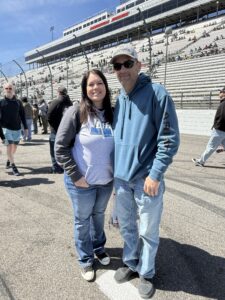 Two RaceAway guests pose for a photo trackside at Martinsville Speedway during the 2026 Cook Out 400.