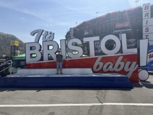 A RaceAway guest stands in front of the “It’s Bristol baby!” display at Bristol Motor Speedway during the 2026 Food City 500.