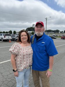 Two RaceAway guests pose together outside Charlotte Motor Speedway before the 2026 Coca-Cola 600.